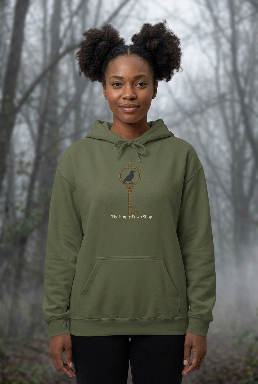 Woman wearing the olive Keyhole hoodie in a cloudy woodland setting